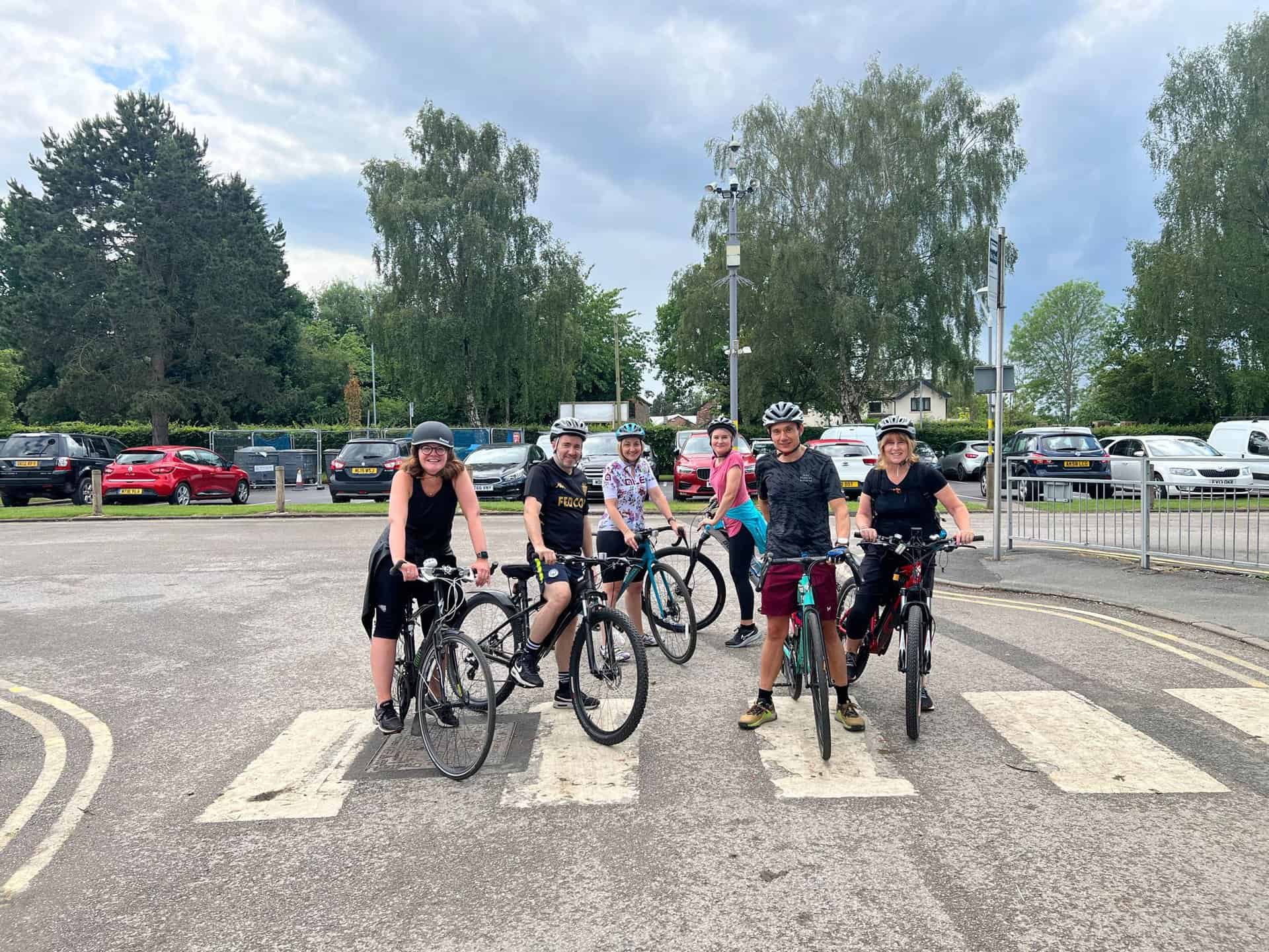 Staff from Hazel Grove High School pose with their bicycles in the car park before their bike ride for Laurus Trust Wellbeing Week.