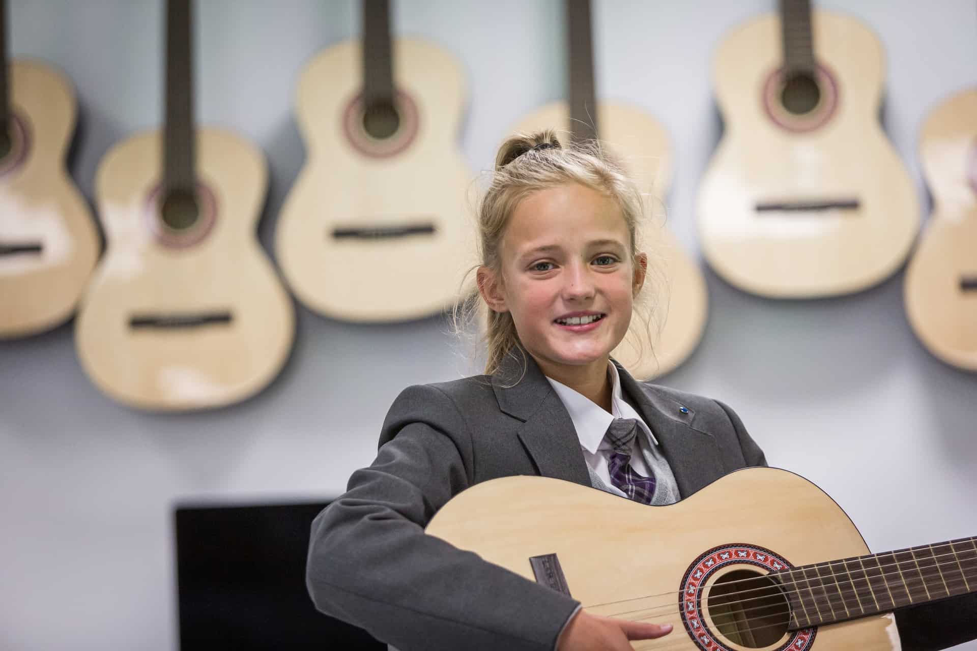 Image of students at a Laurus Trust school playing musical instruments.