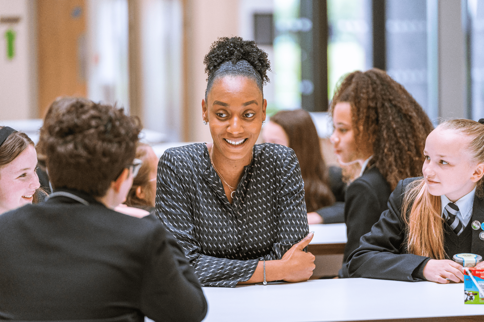 A member of staff speaking with students at one of our Laurus Trust schools. 