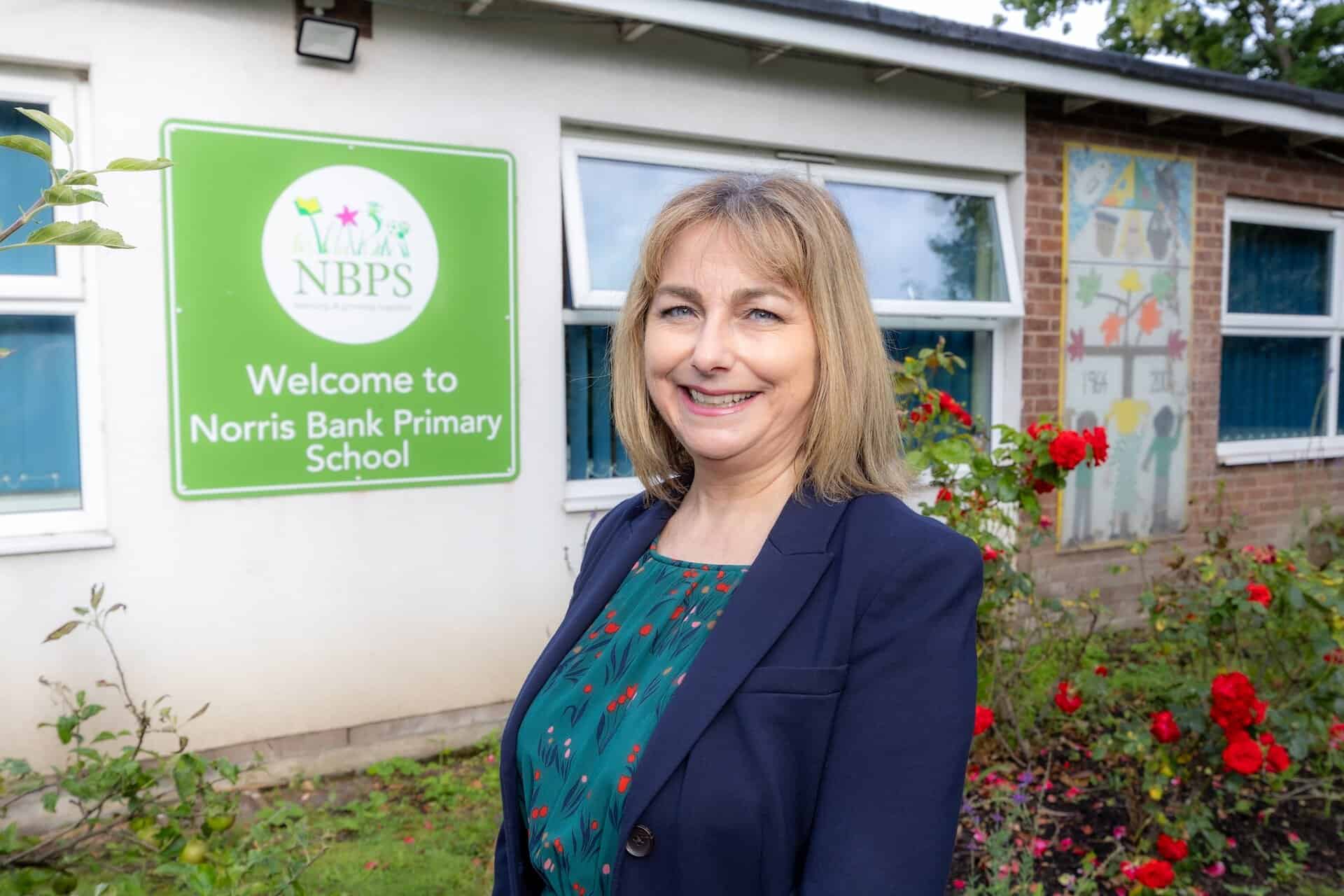 Elena Ponsen, head of school at Norris Bank Primary School, stands in front of the school entrance.