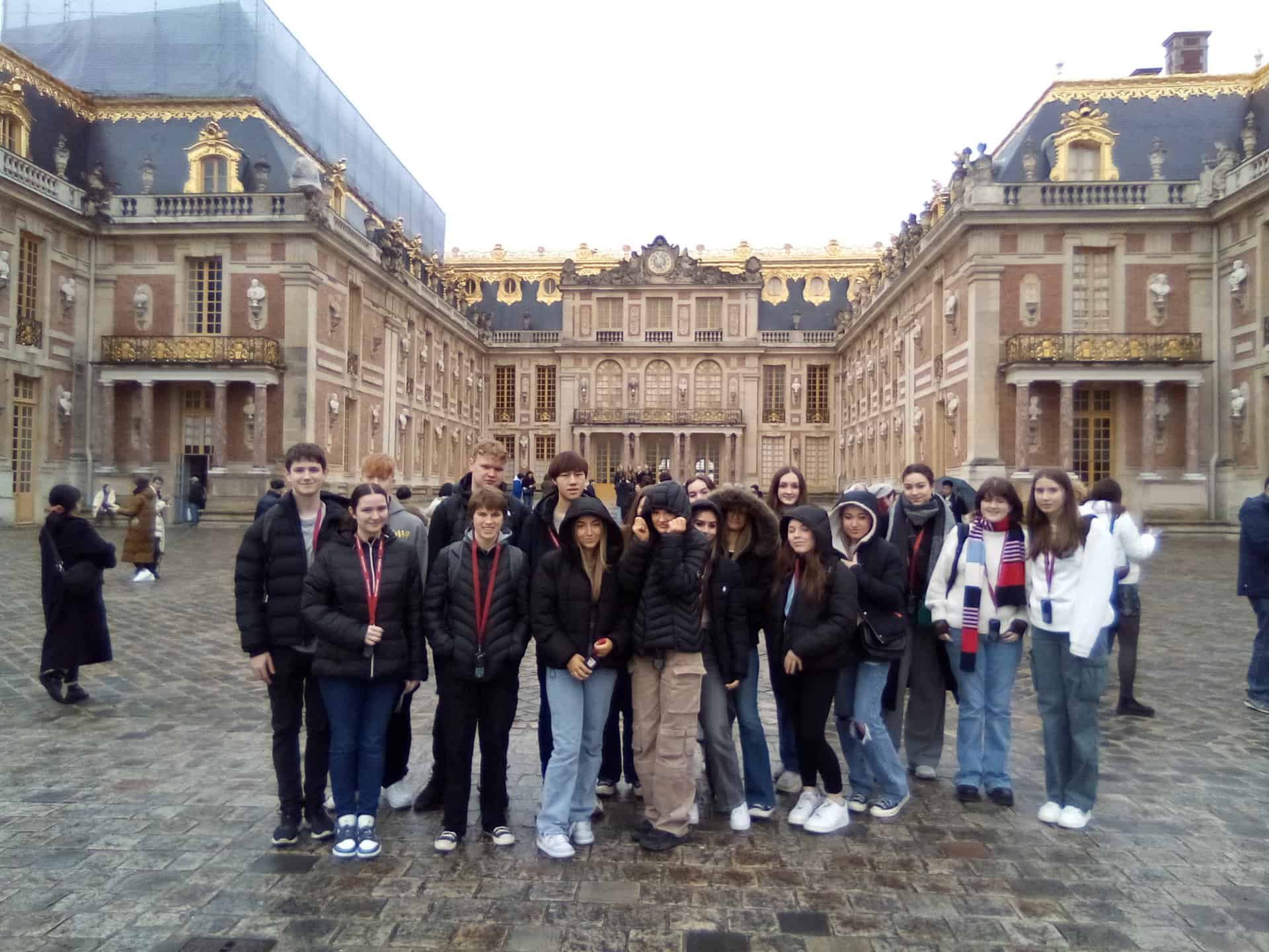 Students from Laurus Trust secondary schools stand outside of the Palace of Versailles