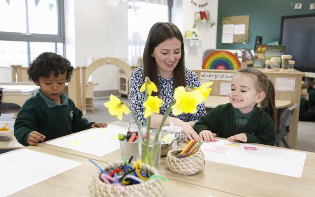 Woodford Primary School teacher helping out pupils with their work.